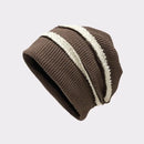 Brown knit beanie with a white stripe on a light gray background, Obroi