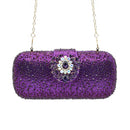 Purple beaded clutch with a decorative brooch on a white background, Obroi