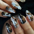 Close-up of a hand with artistic black, white, and gold nail designs, Obroi