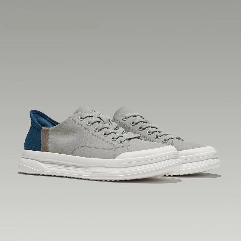 Obroi Gray sneakers with white soles on a gray background, featuring the DESAI brand.