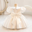 White dress with puff sleeves on a mannequin against a neutral background, Obroi