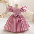 Pink dress with puff sleeves on a mannequin against a decorative background, Obroi