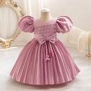 Pink dress with puff sleeves on a mannequin against a decorative background, Obroi