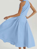 A woman modeling a sleeveless light blue midi dress with a gathered waist and flared skirt, shown against a plain light background, Obroi