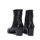 Black leather ankle boots with a block heel on a white background, featuring the brand 'Obroi'.