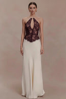 Woman wearing a two-tone evening gown with lace top and white skirt on a plain background, branded 'Obroi'.