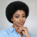 Woman with short, curly black hair wearing a light blue shirt against a plain background, Obroi