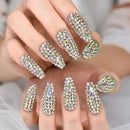 Hand with rhinestone-studded nails on a neutral background, Obroi