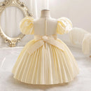 Yellow dress on a mannequin with decorative background, Obroi