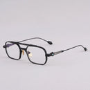 Black eyeglasses on a light gray background, Obroi