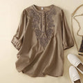 Brown blouse with intricate embroidery on a beige background, Obroi