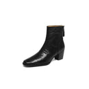 Black leather ankle boot on a white background with a close-up of the sole showing 'Obroi' inside.