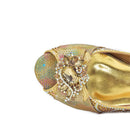 Gold shoe with decorative elements on a white background, Obroi
