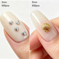 Two close-up nail sample photos side by side showing shell-shaped nail decorations applied on fingernails. The left photo shows four small silver shell charms labeled 3mm, 500pcs; the right photo shows one larger gold shell charm labeled 5mm, 500pcs, Obroi