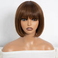 A medium brown bob wig with straight-cut bangs displayed on a mannequin bust against a plain white background, Obroi