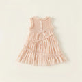 Pink dress with ruffled details on a light beige background ,Obroi