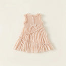 Pink dress with ruffled details on a light beige background ,Obroi