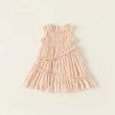 Pink dress with ruffled details on a light beige background ,Obroi