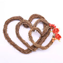 Heart-shaped wreaths made of twigs with floral decorations on a white background, Obroi
