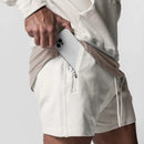 Person wearing a light-colored outfit with a pouch on a plain background, Obroi