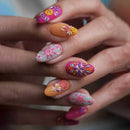Close-up of a hand with colorful floral nail art on a blurred background, Obroi