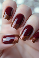 Close-up of hands with burgundy nail polish and glittery edges on a blurred background, Obroi