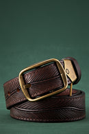 Brown leather belt with a gold buckle on a green background, Obroi