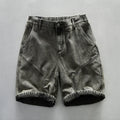 Black denim shorts on a gray background, Obroi