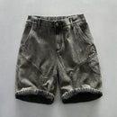 Black denim shorts on a gray background, Obroi