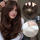 A woman with long, layered brown hair is shown, along with two circular inset close-ups highlighting the hair texture and part detail of what appears to be a wig or hairpiece. Because a person is present, the subject_type is classified as Lifestyle, Obroi