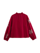 Red blouse with floral embroidery on a white background, Obroi