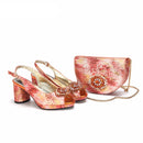 Pair of high-heeled shoes and a matching handbag with floral design on a white background, featuring the brand 'Obroi'.