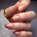 Hand with floral nail design on a neutral background, Obroi