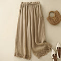 Beige wide-leg pants with lace trim, a woven bag, and shoes on a light background, Obroi