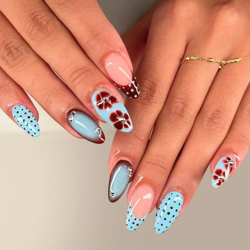 Nails with floral and polka dot design on a neutral background, Obroi