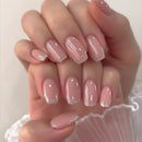Close-up of a hand with pink nails and glittery accents on a white background, Obroi
