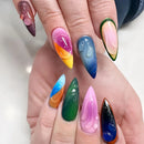 Multicolored nail art on a hand with a white background, Obroi