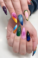 Multicolored nail art on a hand with a white background, Obroi