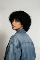 Woman wearing a denim jacket with a plain background, Obroi