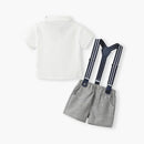 A baby clothing set featuring a white short-sleeve polo shirt and gray textured shorts with navy suspenders that have white stripes, displayed on a clean white background, Obroi