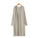 Long beige cardigan on a wooden hanger against a white background, Obroi