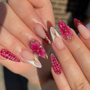 Close-up of hands with pink and gold nail art on a blurred background, Obroi