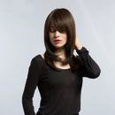 Woman with long brown hair wearing a black top against a light gray background, Obroi