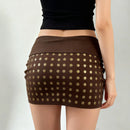 Brown polka dot skirt worn by a person on a plain background, Obroi