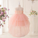 Pink tulle dress on a mannequin against a decorative background with flowers, Obroi