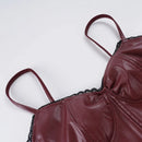 Maroon leather-like top with thin straps on a light gray background, Obroi