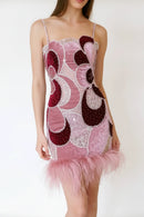 Pink and red patterned dress with feather skirt on a white background, Obroi