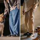 Two people wearing wide-leg pants with a dog in each scene, Obroi