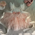 Pink and white dress with floral details on a light gray background, Obroi