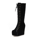 Black knee-high boot with lace-up design on a white background, Obroi